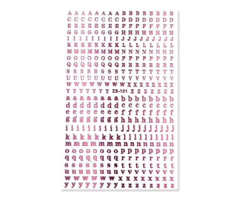 May include: Sheet of alphabet stickers in various sizes and fonts. The stickers are in shades of pink and purple. The text "ZS-101" is printed on the sheet. Ideal for scrapbooking, card making, and other craft projects.