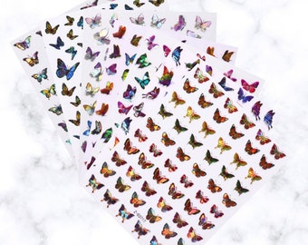 May include: Sheets of butterfly nail art stickers in various colors, including blue, purple, orange, and green. The stickers feature a variety of butterfly designs in different sizes. The stickers are arranged on a white background.