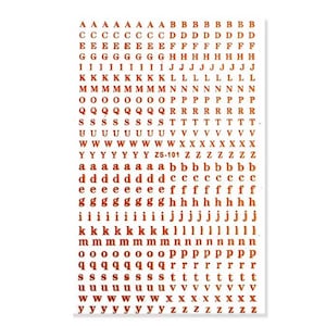 May include: A sheet of brown alphabet stickers featuring uppercase and lowercase letters, numbers, and the text "ZS-101". The stickers are arranged in rows and columns, with each letter and number repeated multiple times.