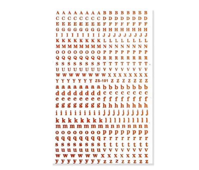May include: A sheet of brown alphabet stickers featuring uppercase and lowercase letters, numbers, and the text "ZS-101". The stickers are arranged in rows and columns, with each letter and number repeated multiple times.