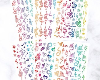 May include: Sheets of colorful snake and celestial-themed nail art stickers. The stickers feature various snake designs, stars, moons, hearts, and butterflies in a rainbow of colors. The stickers are arranged on white sheets.