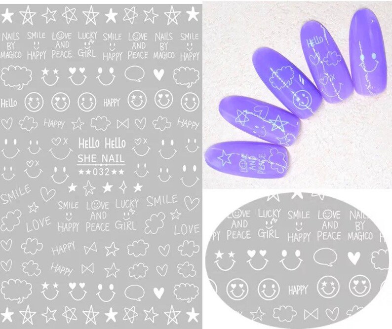 May include: A sheet of nail art stickers with white drawings on a gray background. Designs include stars, smiley faces, clouds, hearts, and text like "Hello," "Smile," and "Love." Also, five purple nail tips with white designs.