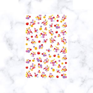 May include: A sheet of colorful dot stickers in red, yellow, orange, pink, and purple. The dots are of varying sizes and are arranged in a random pattern on a white background. The stickers are likely for crafts or decoration.