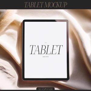 May include: A black tablet computer with a white screen displaying the text "TABLET 4:3 ASPECT RATIO" on a beige fabric background.