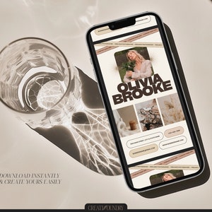 May include: A mobile phone screen displaying a social media post with a collage of images. The post features a woman with brown hair, a floral arrangement, a piece of fabric, and a bouquet of dried flowers. The text "Olivia Brooke" is displayed in brown text on a beige background. The post includes contact information, including a website address and phone number.