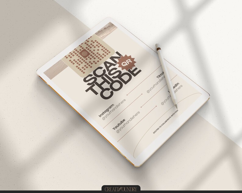 May include: A white tablet with a QR code on the screen. The text on the screen reads "SCAN THIS CODE" and includes social media handles for Instagram, Youtube, Tiktok, and a website. The tablet is on a white surface with a white pencil next to it.