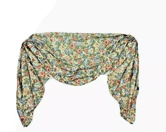 May include: A floral valance with a cream background and pink, blue, and green flowers. The valance is gathered in the center and has a scalloped edge.