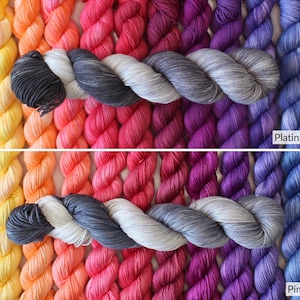 May include: A selection of colourful yarn skeins in shades of yellow, orange, pink, purple, and blue. The image shows two rows of yarn, with a grey skein in the centre. The text "Platinum (wool)" and "Pima Cotton" are visible, indicating the yarn type.