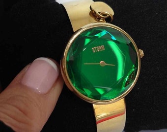 STORM ELEXI Ladies watch with emerald green and  Unique Cut Glass dial with gold tone bracelet strap comes in own box with instruction book.