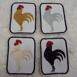 May include: Four embroidered iron-on patches featuring a rooster in different colors: gold, silver, white, and black. Each patch has a white background with a black border.