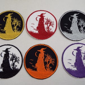 May include: Six embroidered iron-on patches featuring a witch silhouette in different colors. The witch is holding a cauldron and walking through a forest with a crescent moon in the background.