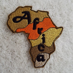 May include: Embroidered patch shaped like the continent of Africa with the word "Africa" written in black letters on a brown, orange, and gold background.