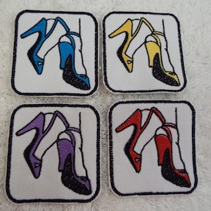 May include: Four iron-on patches featuring a pair of high-heeled shoes in different colors: blue, yellow, purple, and red. Each patch is square and has a white background with a black outline.