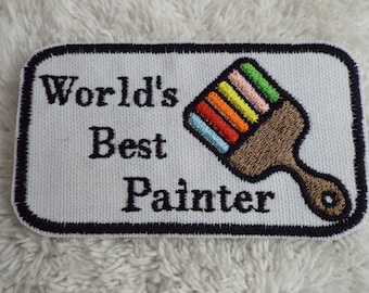 May include: White embroidered patch with black text that reads "World's Best Painter" and a colourful paintbrush design.
