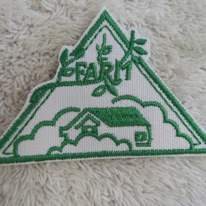 May include: Green embroidered patch with a house, a tree, and the word "FARM" in a triangle shape.