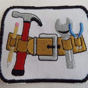 May include: Embroidered patch depicting a tool belt with a hammer, wrench, pliers, and a pencil. The belt is brown with a silver buckle. The tools are silver with blue and red accents.