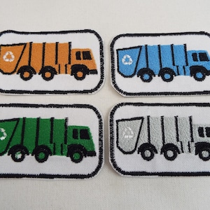 May include: Four embroidered patches depicting a recycling truck in different colours: orange, blue, green, and grey. Each patch has a white recycling symbol on the side of the truck.