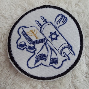 May include: A white embroidered patch with a blue and gold design. The design features a Torah scroll, a menorah, and a Star of David. The patch is circular and has a black border.