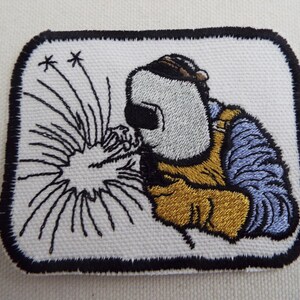Broderad stryklapp med svetsare