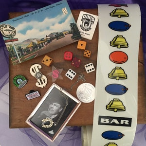 Las Vegas and Nevada Gambling Memorabilia, Includes Several Slot Machine Tapes and Silver Money Clip from The MGM Grand in Reno, NV.