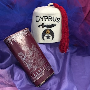Mason Woman’s White Fez with Red Silk Tassel. Cira 1880’s with Original Decorative Case. Traditional Mason Emblem. In Good Condition.