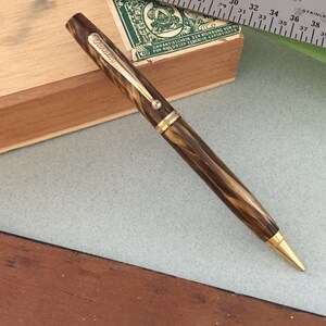 Varsity Writing Pencil. 60’s or 70’s Vintage. Handsome Simulated Wood Grain Finish with Gold Toned Highlights.