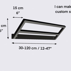 May include: Black metal shelf with two tiers, measuring 6 inches tall and 12 to 47 inches wide. The shelf is shown with measurements in both inches and centimeters.  I can make a custom size.