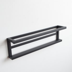 Modern black wall mounted shoe rack with minimalist look