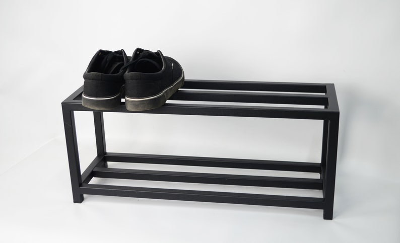 A black metal tier shoe rack.