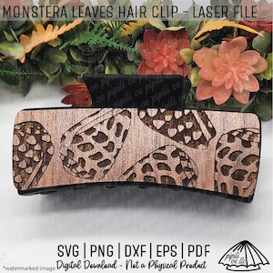 May include: Wooden hair clip with a laser-cut monstera leaf design. The clip is brown with a black base and features a repeating pattern of the tropical leaves. The text "MONSTERA LEAVES HAIR CLIP - LASER FILE" is at the top.