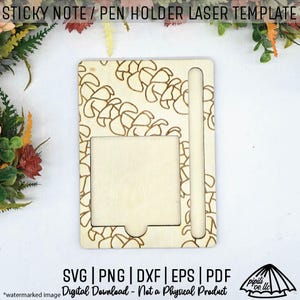 May include: A wooden sticky note and pen holder laser template. The rectangular holder has a square cutout for notes and a slot for a pen. The surface is decorated with a repeating floral pattern. The text "SVG | PNG | DXF | EPS | PDF" is visible.