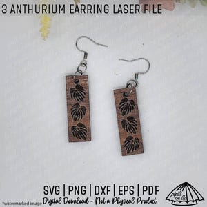 May include: Wooden earrings with a rectangular shape and a leaf design. The earrings are brown with a silver hook. The text "3 ANTHURIUM EARRING LASER FILE" is at the top. The bottom text says "SVG | PNG | DXF | EPS | PDF Digital Download - Not a Physical Product".