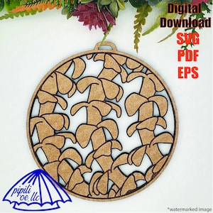 May include: A brown wooden ornament with a circular design of cut-out mushrooms. The ornament is a digital download and available in SVG, PDF, and EPS formats.