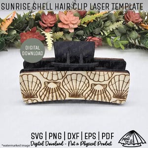May include: A wooden hair clip laser template with a seashell design. The clip is light brown with a dark brown seashell pattern. The text "SUNRISE SHELL HAIR CLIP LASER TEMPLATE" is at the top. The words "DIGITAL DOWNLOAD" are also visible.