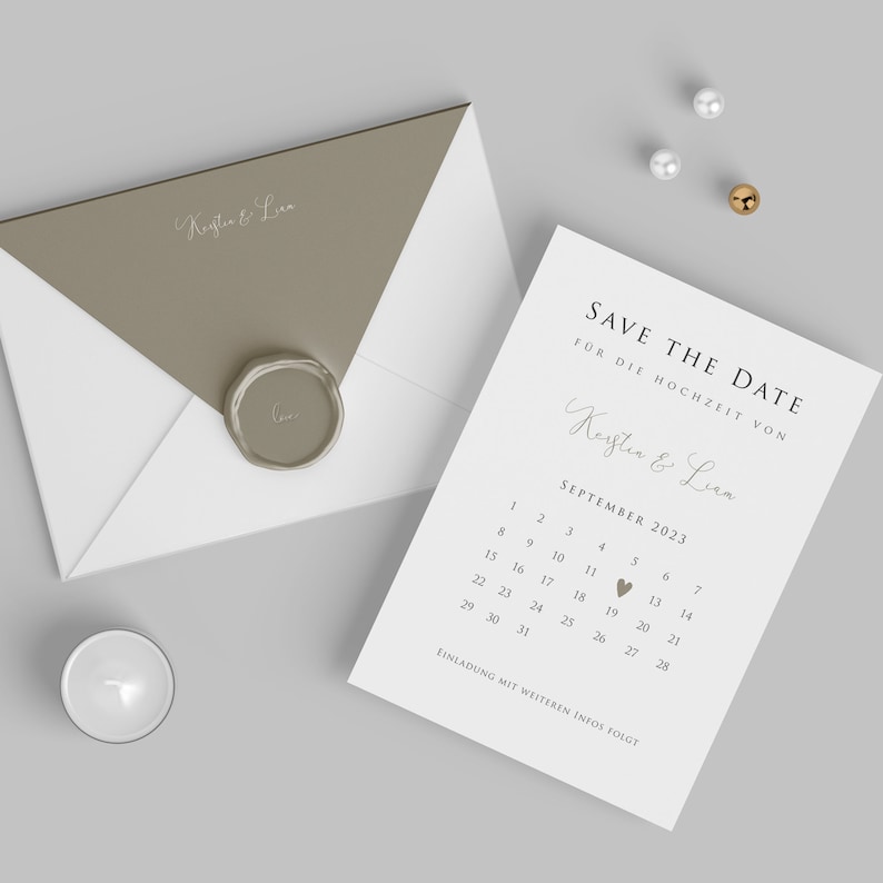 May include: A white card with a brown heart and the text "SAVE THE DATE" for the wedding of Keyten & Lien. The date is September 11, 2023.