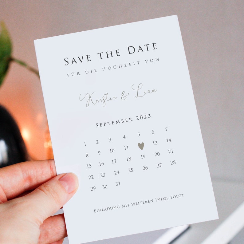 May include: Save the date card with a calendar for September 2023. The date of the wedding is marked with a heart on the 5th. The card reads "Save the Date" and "For the wedding of Kerstin & Liam".