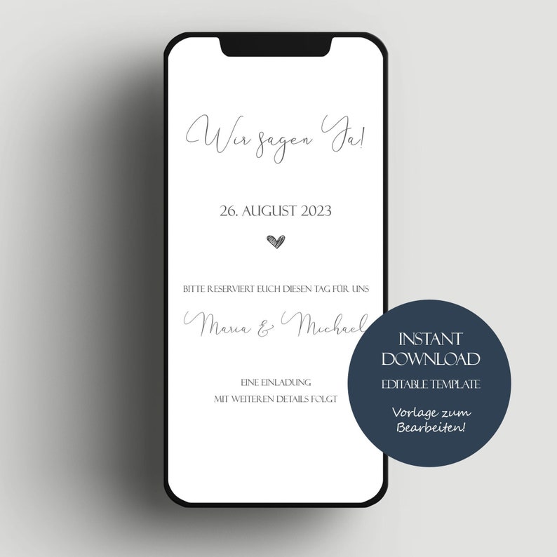 May include: A white smartphone screen with a wedding announcement. The text reads "Wir sagen Ja!" and "26. AUGUST 2023". The announcement also includes the names "Maria & Michael" and the text "BITTE RESERVIERT EUCH DIESEN TAG F&Uuml;R UNS". The screen is surrounded by a black border.