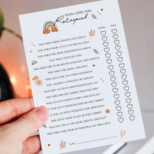 May include: A printable baby shower game in a light blue color with a rainbow design. The game asks questions about the parents, such as who will change more diapers, who will be stricter, and who will read more to the baby. The game has a space for the players to mark their answers with hearts.
