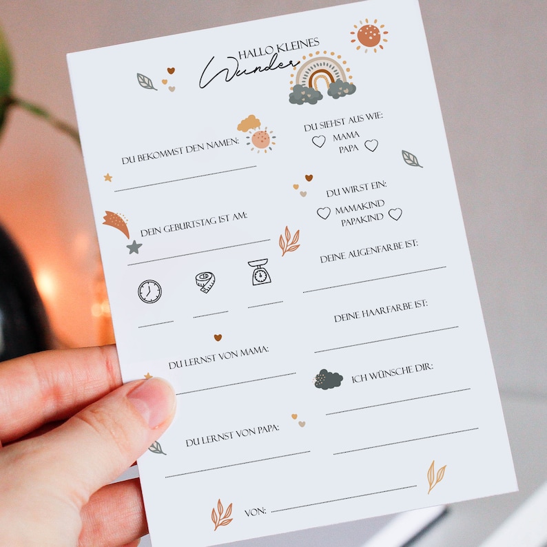 May include: A printable baby shower game card with a light blue background and colorful illustrations. The card has a title that says "Hallo Kleines Wunder" and includes prompts for guests to fill in information about the baby, such as the baby's name, birthday, and eye color.