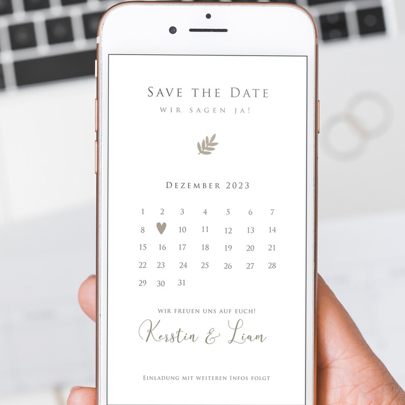 May include: A digital save the date announcement on a smartphone screen. The announcement is for a wedding in December 2023. The couple's names are Kerstin and Liam. The text reads "Save the Date, Wir sagen Ja!" and "Wir freuen uns auf euch!"