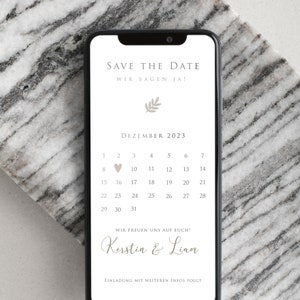 May include: A digital save the date announcement for a wedding in December 2023. The announcement features a calendar with a heart marking December 2nd, the names Kerstin & Liam, and the text "Save the Date, Wir sagen Ja!" and "Wir freuen uns auf euch!"