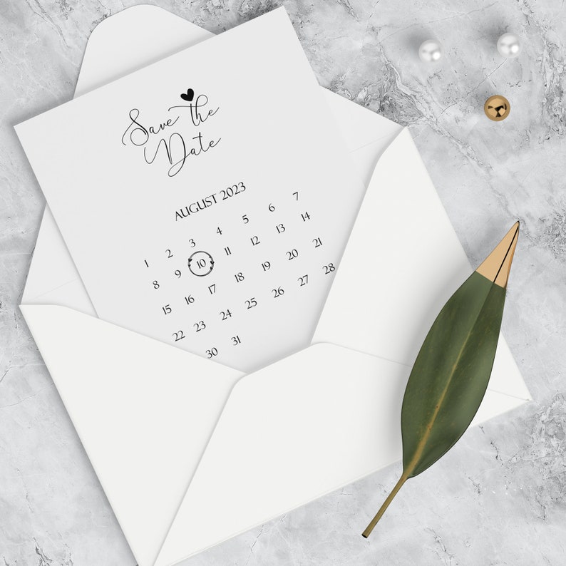 May include: A white envelope with a white card inside. The card has the text "Save the Date" and a calendar with the date August 10th circled.