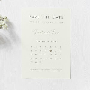 May include: Save the date card with a calendar for September 2023. The date September 19th is highlighted with a small heart. The card is beige with brown text and reads "Save the Date" and "For the wedding of Kerstin & Liam".
