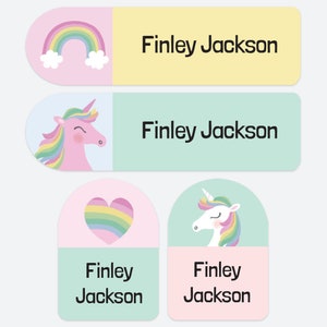 May include: Four rectangular and rounded labels featuring the name Finley Jackson in black text. Two long labels display a rainbow and a pink unicorn respectively. Two smaller labels feature a rainbow heart and a white unicorn with a colourful mane.