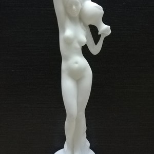 May include: White marble statue of a woman holding a pitcher above her head. The statue is standing on a square base.