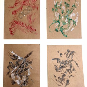 May include: Four abstract art pieces on brown paper. The first piece is red with white swirls and three faces. The second piece is green with white swirls. The third piece is black and white with swirls. The fourth piece is black and white with swirls.