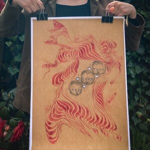 May include: A brown paper print with a red and white abstract design. The design features multiple stylized faces with closed eyes.