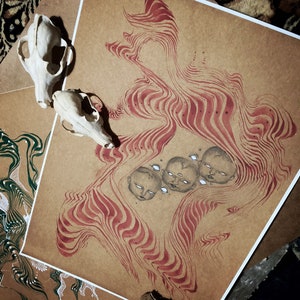 May include: A brown paper print with red and white lines and a pattern of four faces with closed eyes. The faces are drawn in black and white and are surrounded by a swirling pattern of red and white lines.