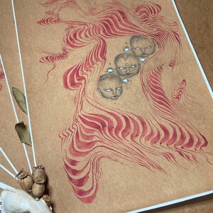 May include: A brown paper print with a red and white abstract design. The design features a series of swirling lines and shapes that resemble a flowing liquid. There are five small faces with white eyes and black pupils in the centre of the design.