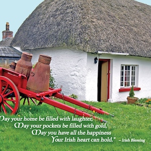 May include: A red wooden cart with two rusty milk cans sits in front of a white cottage with a thatched roof. The cottage has a red door and windows. The cart is on a green grassy lawn. The text reads: 